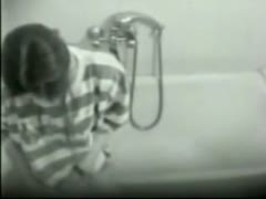 On the camera concealed in the bathroom, a sexy wife massages and masturbates her pussy.